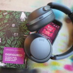 green and purple book cover, title, Disfigured on Fairy Tales, Disability, and Making Space. Headhphones and audio book on screen, title "Wild Life"