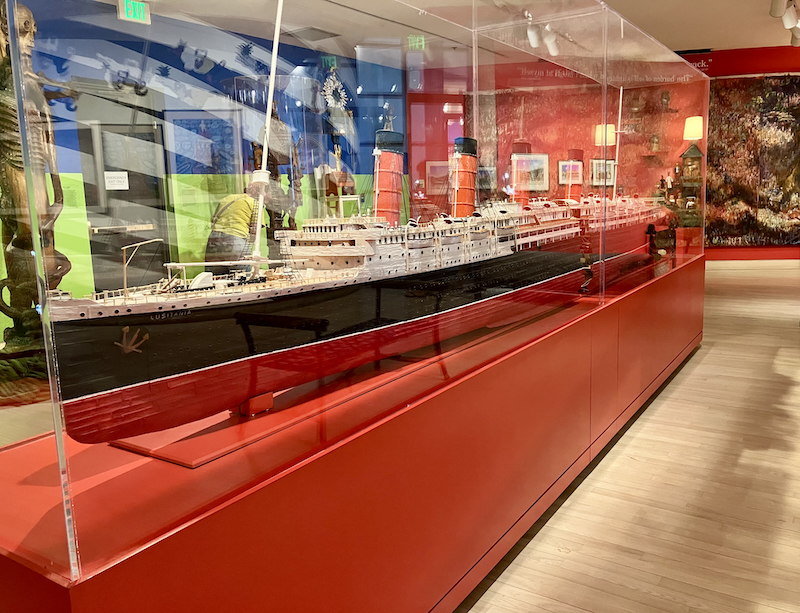 Ocean Liner model made of toothpicks on a red museum stand with a plexi-glass top.